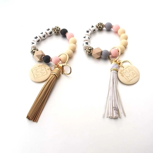 Close-up of MAMA engraved wood tags and colorful silicone bead wristlet keychains