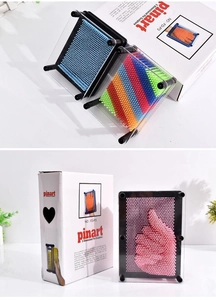 Macro view of 3D pin art toy showing colorful plastic pins creating hand impressions