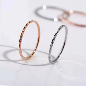 Close-up of rose gold and silver textured faceted rings with elegant light reflection