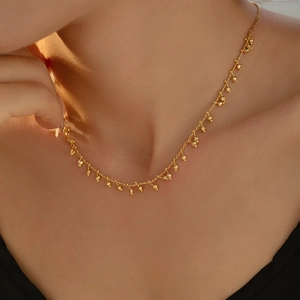Elegant 18k gold plated beaded gourd tassel necklace worn as a minimalist choker
