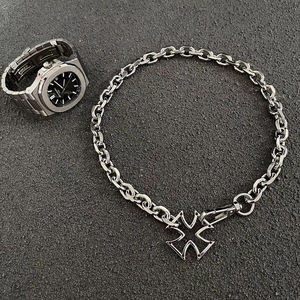Hip hop silver cuban chain necklace with hollow cross pendant on dark textured background