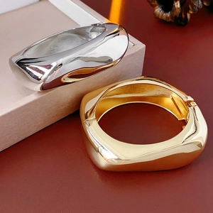Irregular chunky metal open bracelets in gold and silver finish with hinged closure