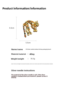 Detailed view of panther brooch featuring gold finish with black and orange enamel inlay