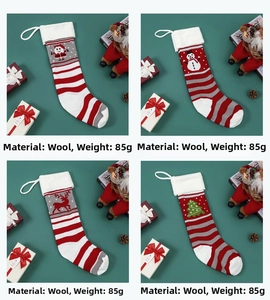 Detail of four knitted Christmas stockings with Santa, snowman, and reindeer patterns