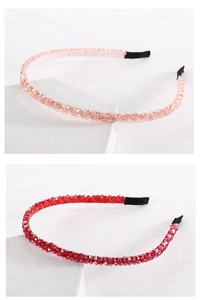 Detail of handmade champagne and red crystal beaded headbands on white stone display