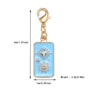 Detail view of a light blue enamel tarot charm with sun motif and gold finish