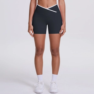 Detail of high-waisted yoga shorts featuring cross V-waist design and white contrast piping