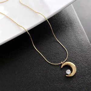 Titanium steel moon necklace with gold crescent pendant and sparkling cubic zirconia