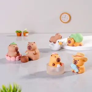 Miniature resin capybara figurines in various cute poses like fishing and riding a duck
