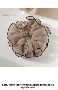 Detail of beige large scrunchie with pleated fabric and contrast black trim edge