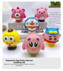 Set of cartoon squishy toys including strawberry bear and cat burger on a white desk