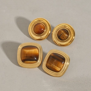 Detailed view of vintage gold titanium earrings with round and square tiger eye stones