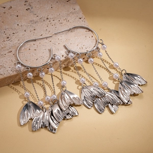 Silver fishtail tassel C-shaped earrings with pearls and leaf charms on a stone