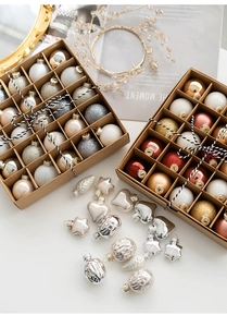 Flat lay of champagne gold Christmas balls and star ornaments in decorative box