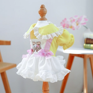 Detail of yellow dog princess dress with white lace layers and pink teddy bear embroidery