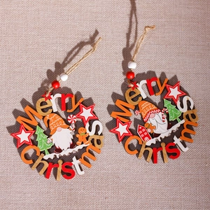 Wooden Christmas ornaments with Santa and star motifs on a beige textured background