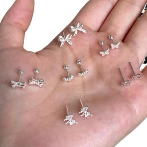 Silver S925 butterfly and star stud earrings set displayed on a hand with detailed finish
