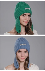 Detailed close-up of knit texture and brand label on winter rabbit ear flap beanies