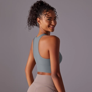 Detail view of the racerback sports bra and high-waist yoga pants in professional grey studio