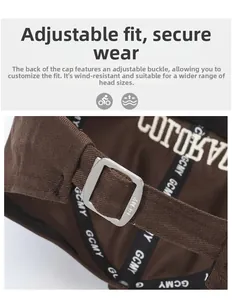 Detail of adjustable metal buckle and embroidered canvas strap on baseball cap