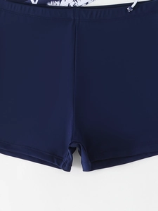 Detail of navy tankini bottoms with elastic waistband, drawstring, and knit texture
