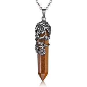Detail of vintage tiger eye hexagonal pendant with antique silver floral embossed wrap