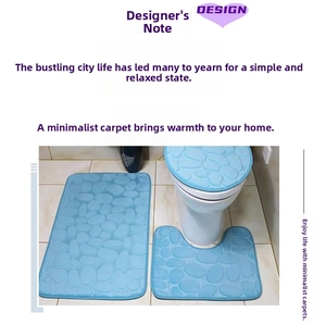 Close-up of blue 3-piece bathroom mat set with embossed pebble texture and non-slip back