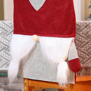Detail showing plush gnome Christmas chair cover with red felt hat and fluffy white beard