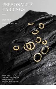 Macro shot of gold-plated S925 sterling silver huggie earrings with micro-pave cubic zirconia