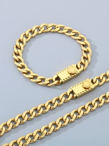 Close-up of gold stainless steel Cuban chain necklace and bracelet set with rectangular clasp