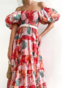 Detailed view of the colorful floral print and layered cake hem on this maxi vacation dress