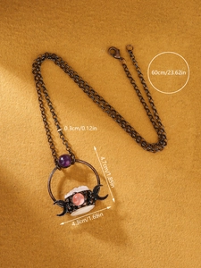 Vintage bronze triple moon necklace with rose quartz and amethyst stones on textured background