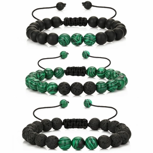 Detail of beaded bracelets with malachite, matte black beads and lava stone textures