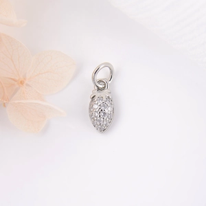 Sparkling silver strawberry pendant with inlaid zircons on a clean white background