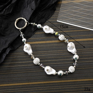 Detail of ghost charm phone strap featuring resin beads and rhinestones, 15cm length