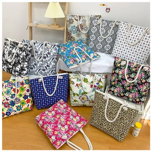 Various printed canvas tote bags with rope handles in floral, leopard, and geometric patterns