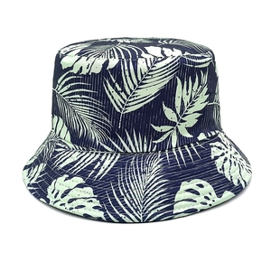 Detail view of reversible sun hat with tropical monstera leaf print on navy blue fabric