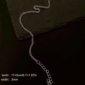 Minimalist silver NK chain bracelet 3mm width on dark stone texture background
