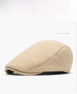 Detail view of the beige wool blend fabric texture on this classic flat cap