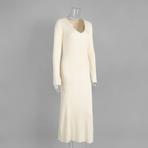 Detail of V-neck long sleeve cream knit dress with vertical ribbed texture and slim fit