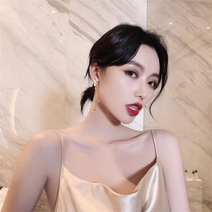 Elegant long faux pearl tassel earrings with golden chain on a female model