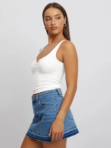 Slim fit white ribbed U-neck tank top paired with dark blue denim skirt for summer style