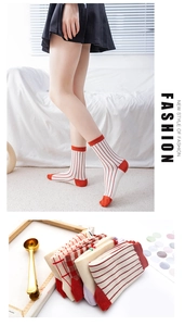 Detail of vintage Japanese style cotton socks with red stripes and check patterns
