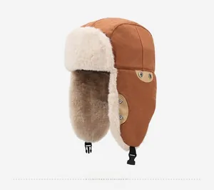 Detail view of winter trapper hat with thick brown canvas and warm white faux fur lining