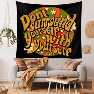 Detail of bohemian rainbow wall tapestry above a sofa with vintage circular stripe pattern