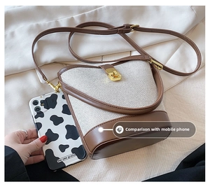 Brown and cream bucket bag size comparison with smartphone showing compact dimensions