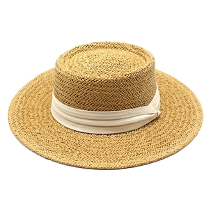 Classic wide brim straw boater hat with a cream ribbon band for summer beach sun protection