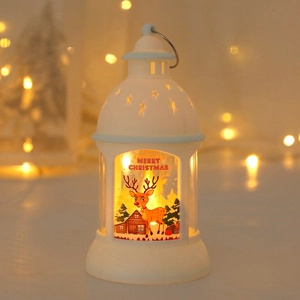Detail of white Christmas lantern featuring Merry Christmas text and reindeer motifs with LEDs