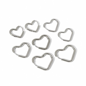 Set of eight minimalist silver heart hoop earrings in polished stainless steel for women
