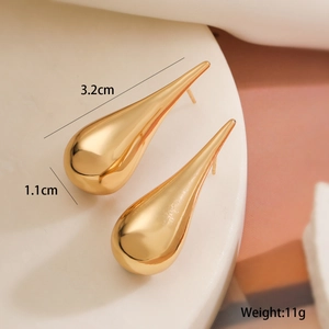 Detail view of 18K gold plated teardrop earrings with 3.2cm x 1.1cm dimensions and 11g weight
